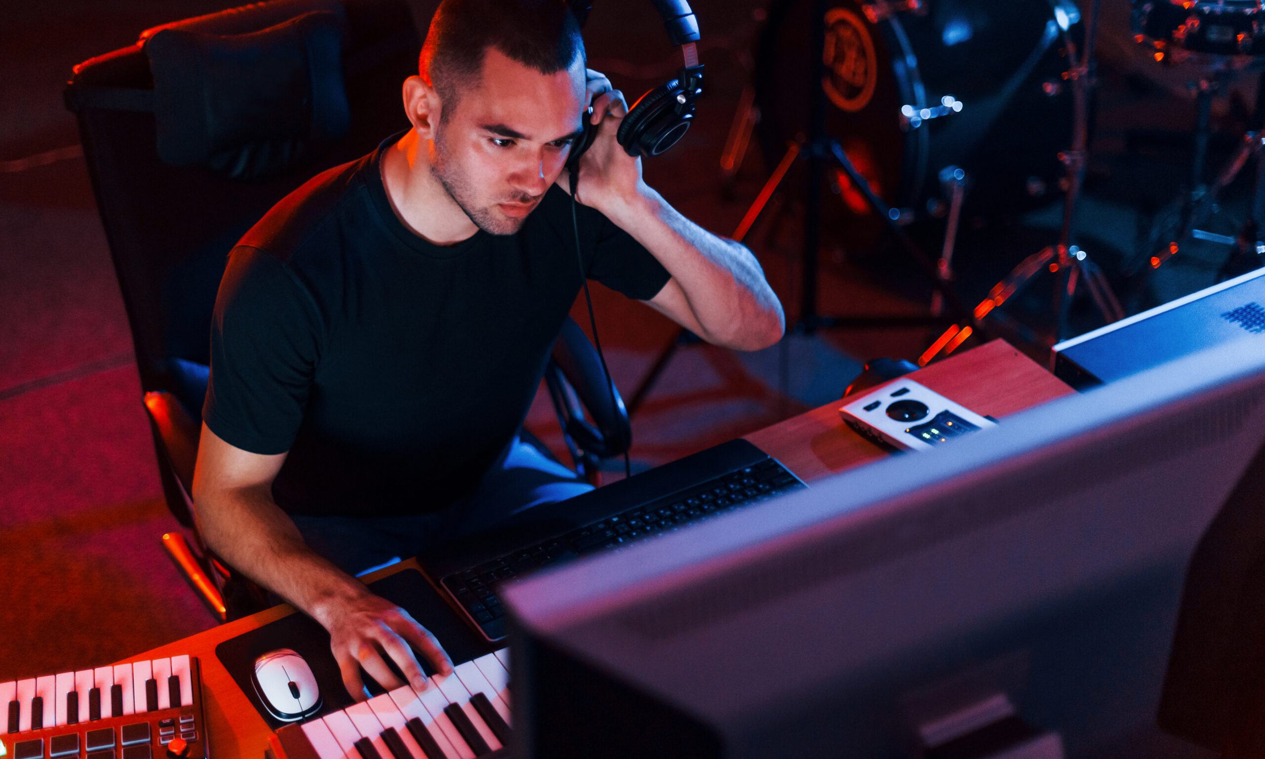 Sound engineer working and mixing music indoors in the studio